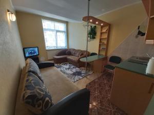 a living room with a couch and a table at Atgiris in Palanga