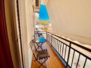 a balcony with a table and a view of a street at Eleutheria Rooms in Igoumenitsa +14 photos