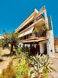 a building with plants in front of it at Eleutheria Rooms in Igoumenitsa