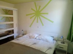 a bedroom with a bed with a star on the wall at Apartmaji Iris Kobarid in Kobarid