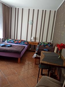 a bedroom with two beds and a table and a table sidx sidx sidx at El Jan Pobierowo in Pobierowo