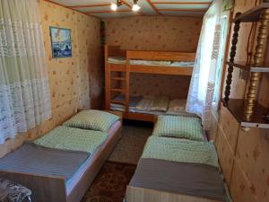 a room with three bunk beds and a window at Na kemping! in Pobierowo