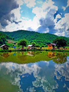 a large body of water with houses and trees at Samoeng fishing park home stay in Samoeng