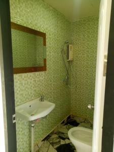 a bathroom with a sink and a toilet at Samoeng fishing park home stay in Samoeng +68 photos