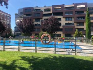 a swimming pool in front of a building at Apartamento Mercedes in Logroño