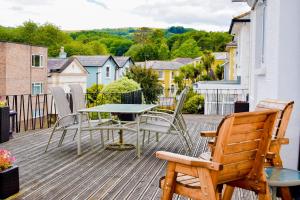 a patio with a table and chairs on a deck at Braemar in Shanklin