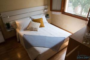 a bedroom with a large bed with pillows on it at La Casa di Zucchero in Classe