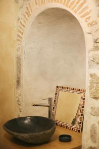 baño con lavabo negro y espejo en Les Gîtes du Couvent en Ardèche - Gîte de groupe en Nozières