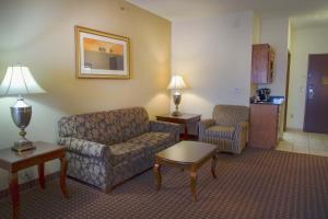a living room with a couch and a chair at Holiday Inn Express Hotel & Suites Center, an IHG Hotel in Center