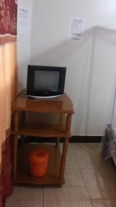 a small table with a laptop on top of it at Hotel Delambiance in Koboko