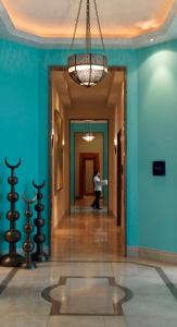 a hallway with blue walls and a chandelier at Four Seasons Hotel Istanbul at the Bosphorus in Istanbul