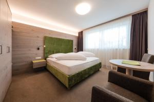 Postel nebo postele na pokoji v ubytování Hotel & Residence Rebhof