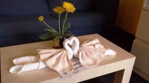 a table with towels and a vase with flowers on it at Apollo Inn - Cocoa in Cocoa