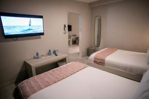 Postel nebo postele na pokoji v ubytování Trópica Beach Hotel