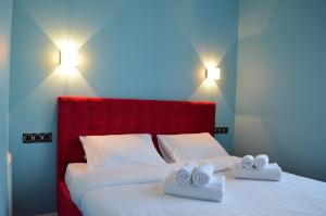 a bedroom with a bed with two towels on it at Arena,VIP in Kyiv
