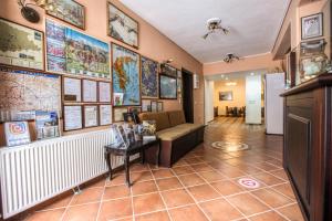 a room with a couch and maps on the wall at Alsos House in Kalabaka