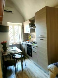 a kitchen with a table and a kitchen with a stove at Apartment Mary in Terracina