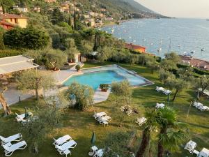 a resort with a swimming pool next to the ocean at Hotel Baia Verde in Malcesine
