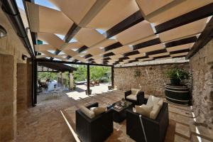 an outdoor living room with a wooden ceiling at Villa Dvori Dida Mile in Sveti Petar +69 photos