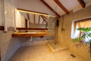 a bathroom with a sink and a glass shower at Woodland Resort in Kragujevac +59 photos