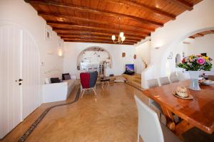 a living room with a wooden ceiling and a table at Villas Kappas in Agios Sostis Mykonos