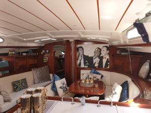 a living room with a table in the back of a boat at LUXURY YACHT STAY "White Dove" sleeps 6 in Gibraltar