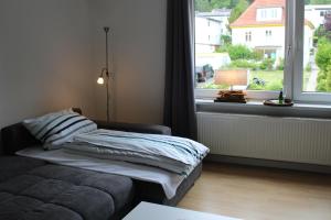 a living room with a couch and a window at Ferienwohnung Ruheoase in Bad Harzburg