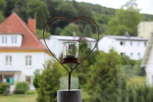 a glass cup in the shape of a heart at Ferienwohnung Ruheoase in Bad Harzburg