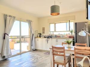 a kitchen and dining room with a table and chairs at Nof Beresheet in Midreshet Ben Gurion