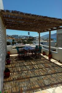 a patio with a table and chairs on a roof at MARGARITA'S-STUDIOS in Koufonisia