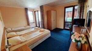 a hotel room with a large bed and a television at Hotel Villa Bora in Sunny Beach