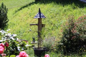 a small bird house in the middle of a garden at Bauerndörfl Hüttschlag in Hüttschlag