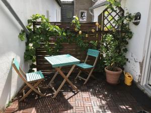 two chairs and a table on a patio at Schräges Haus in Treis-Karden