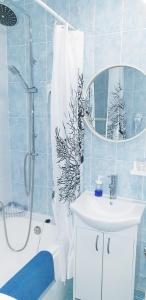 a bathroom with a sink and a shower with a mirror at Cosy&White apartment in Daugavpils in Daugavpils +22 photos