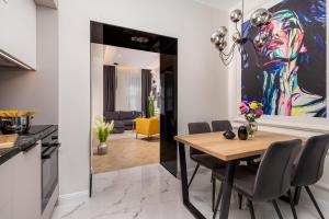 a kitchen and dining room with a table and chairs at Luxury Number 1 Apartments in Rijeka