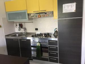 a kitchen with a stainless steel stove and a sink at Casa delle sorprese in Pescara