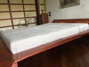 a bed with white sheets on it in a room at Casa delle sorprese in Pescara