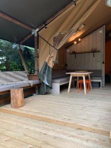 a tent with a table and benches in it at Glamping Wolfskuilen in Lieren