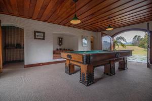 a large room with a pool table in it at Pousada Mansão Edelweiss in Campos do Jordão