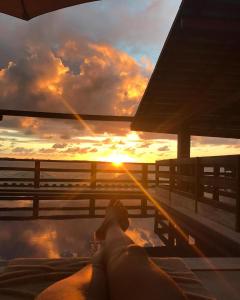 a man laying in a hot tub on a boat with the sunset at Alfa Beach (Adults only) in Cacha Pregos