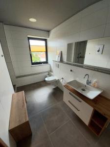 a bathroom with a sink and a toilet at Ferienwohnung Nikolena in Pirmasens