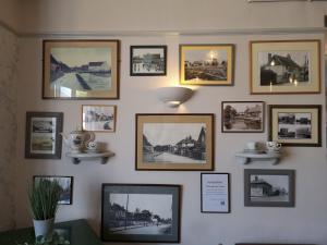 a wall filled with pictures on a wall at Woolpack Inn in Chichester