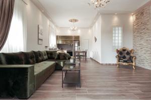 a living room with a green couch and a table at Eleana Luxury Private Apartment in Neos Marmaras
