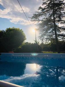 a reflection of the sun in a swimming pool at B&B Villa dei Sogni in Eboli