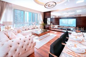 a living room with a couch and a tv at Elite Royal Apartment - Burj Residences T5 | VIP in Dubai