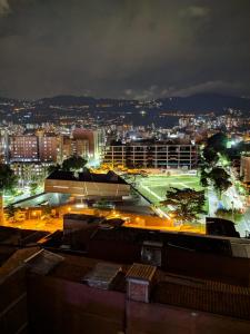 a view of a city at night with lights at Arame Hotel in Envigado