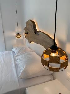 a bedroom with a bed with a chandelier and a log headboard at Eternal Town in Mikonos