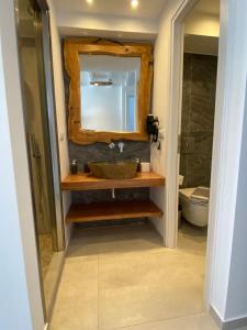 a bathroom with a sink and a mirror at Eternal Town in Mikonos