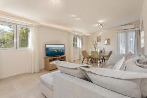 a white living room with a couch and a table at Michaelo Villa - Affordable Luxury! in Kalamaki