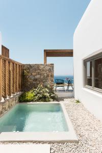 a swimming pool in the backyard of a house at Mykonos Soul Luxury Suites in Agios Stefanos